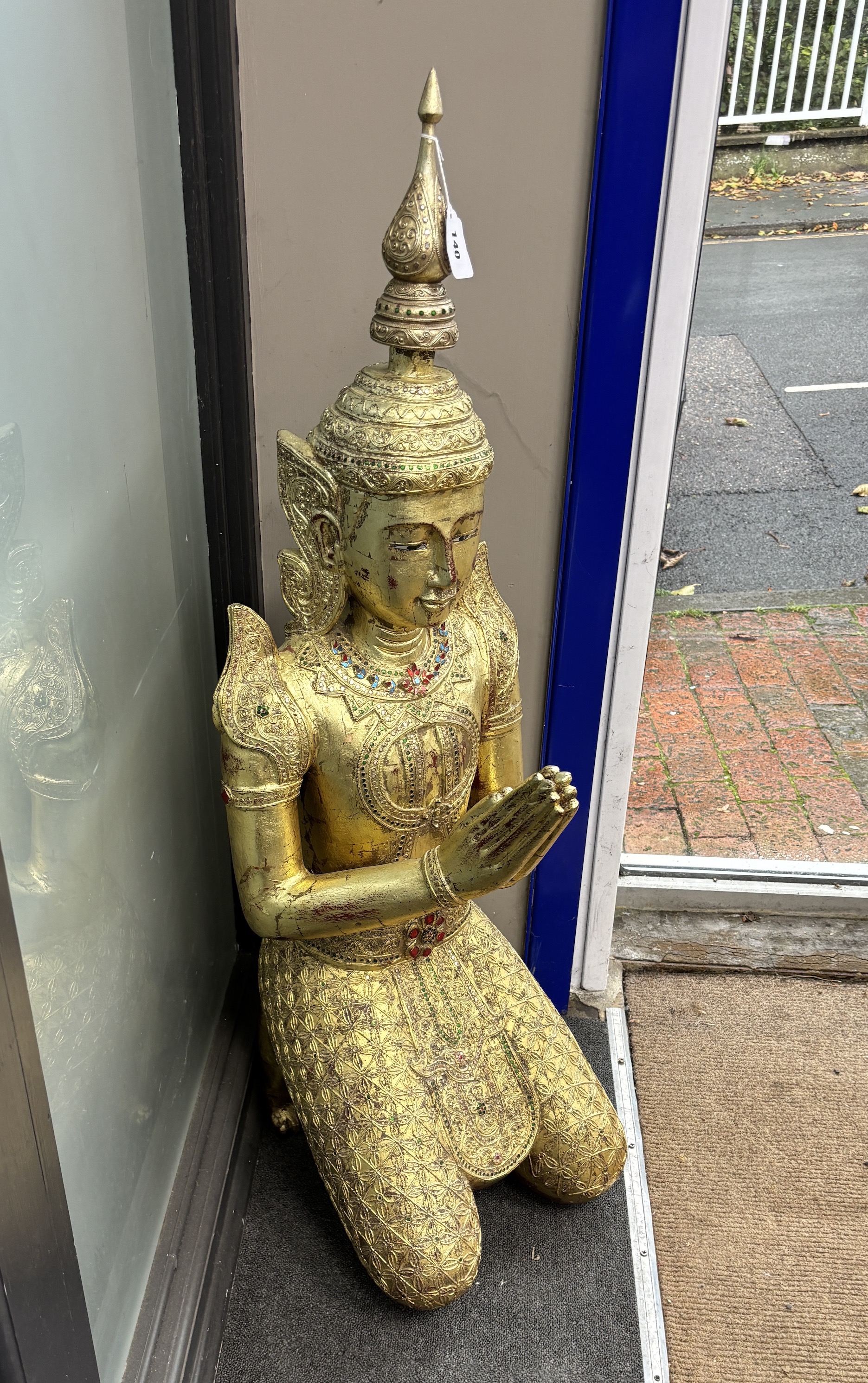 A large 20th century Thai giltwood guardian angel temple figure inset coloured glass decoration, height 114cm